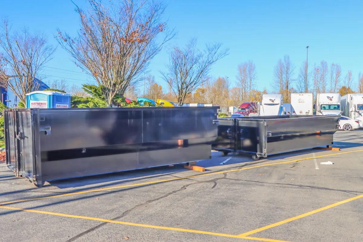 Professional dumpster rental service with roll-off container on residential driveway in Suitland